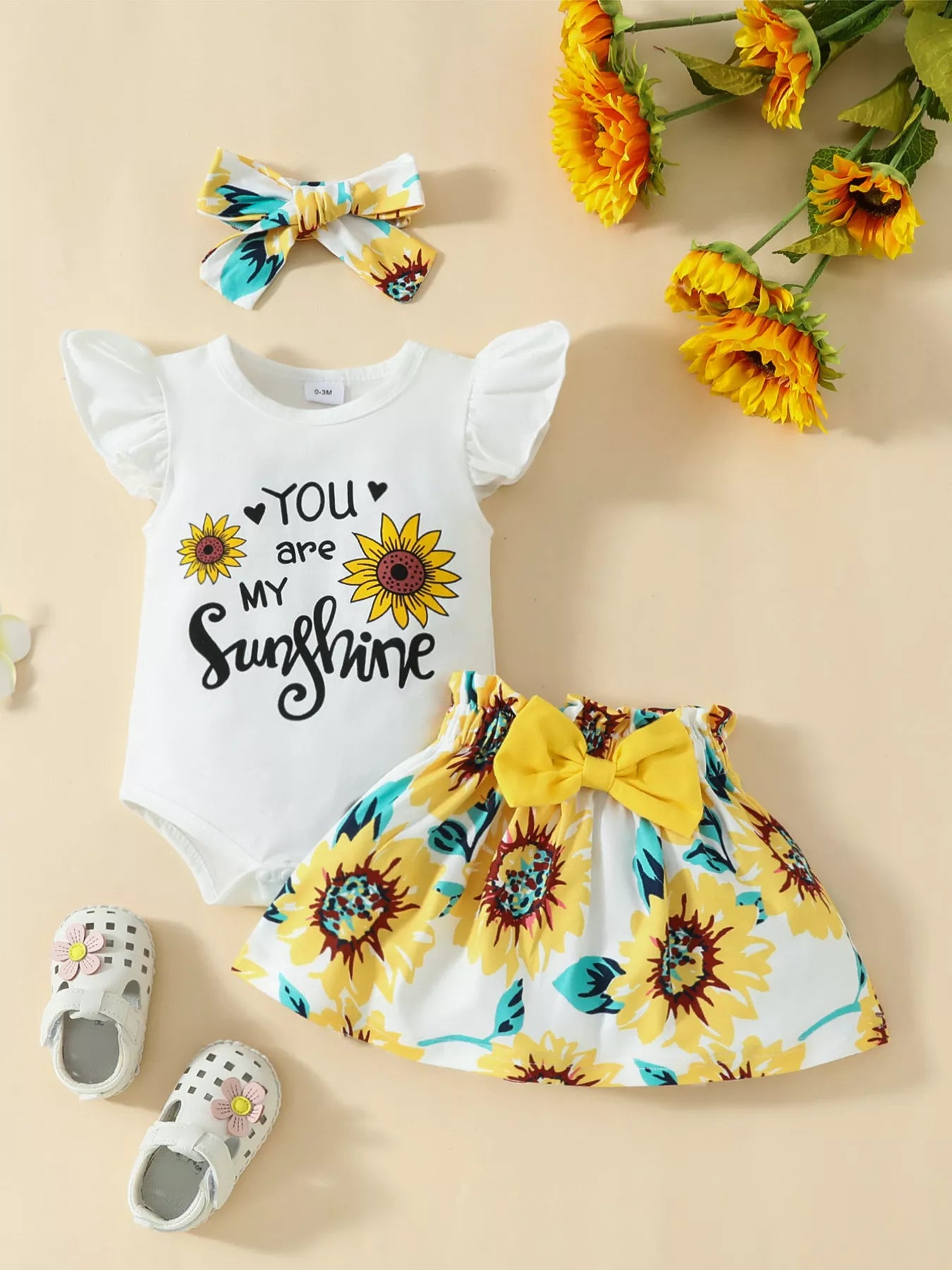 “Sunflower baby girl outfit with ruffled bodysuit, skirt, and headband”