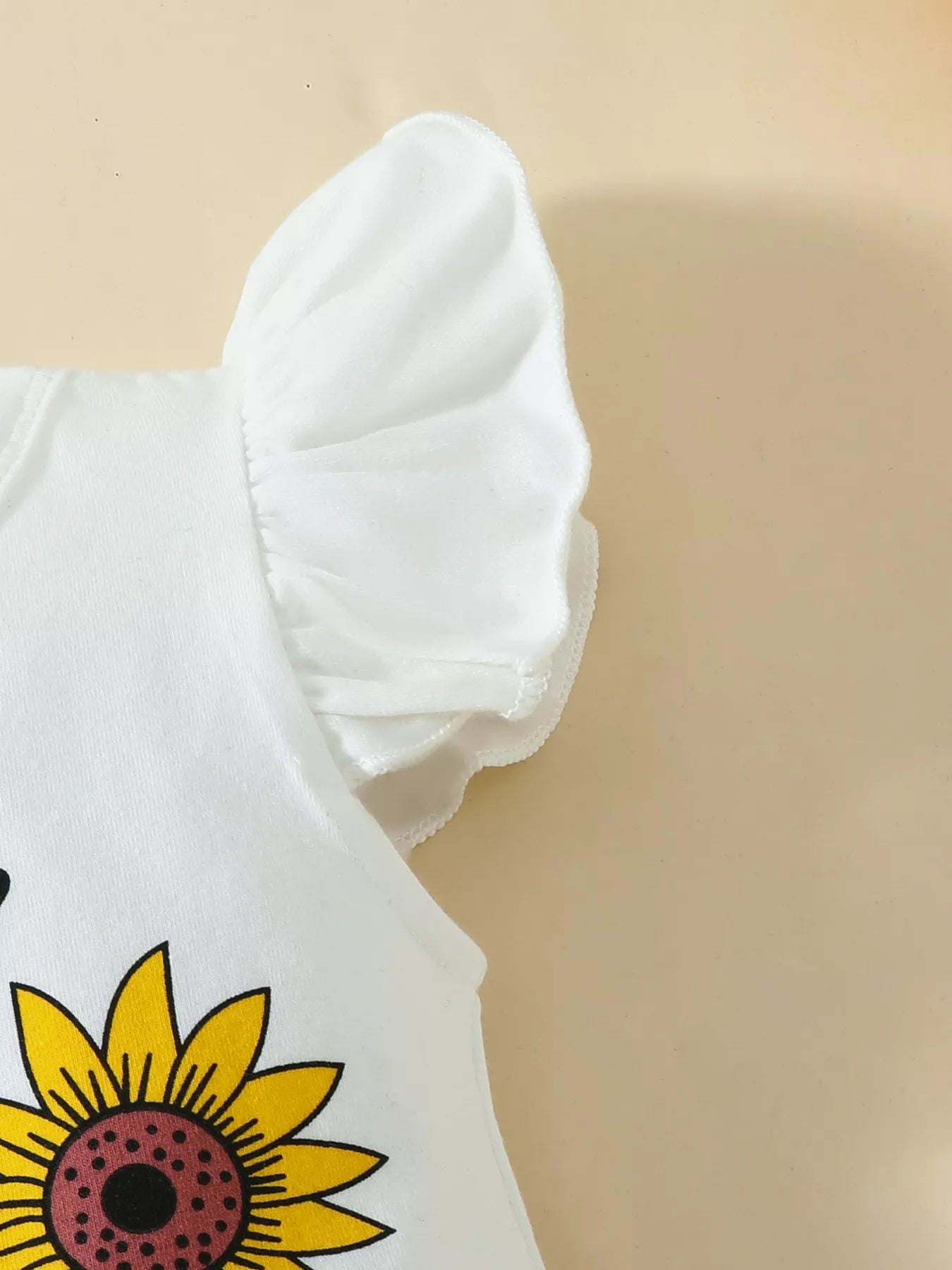 “Sunflower baby outfit flat lay, 3‑piece set”