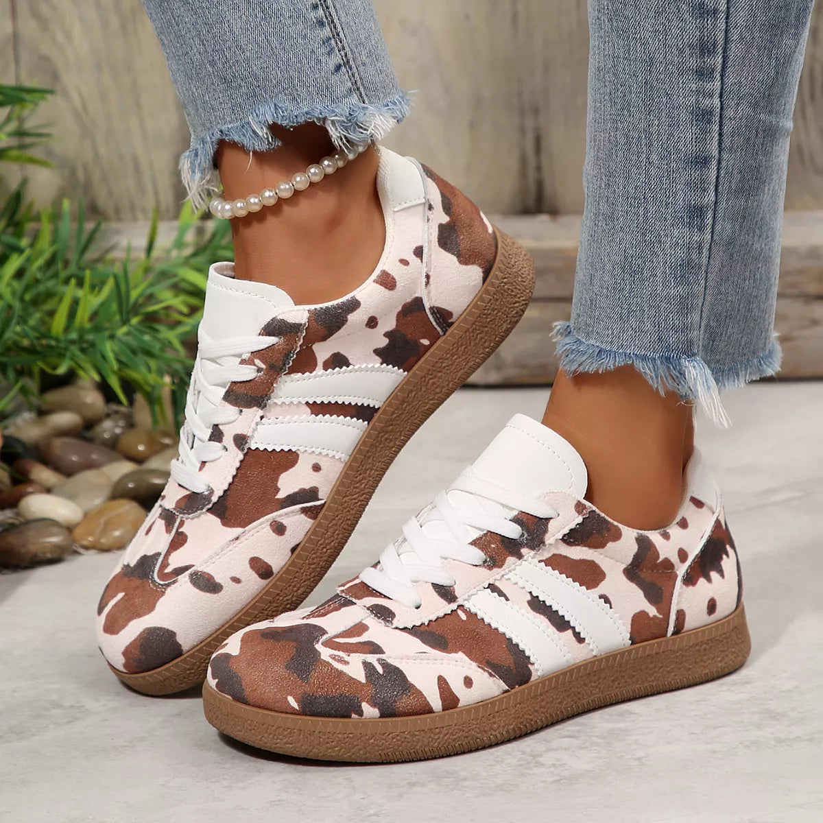Women's brown cow print sneakers, side view