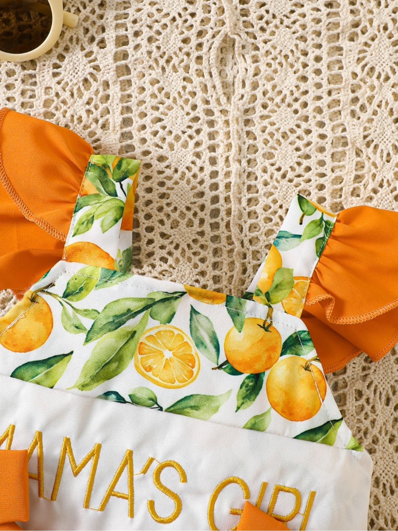 “Infant cow print romper with ruffle trim, sherbet color”
