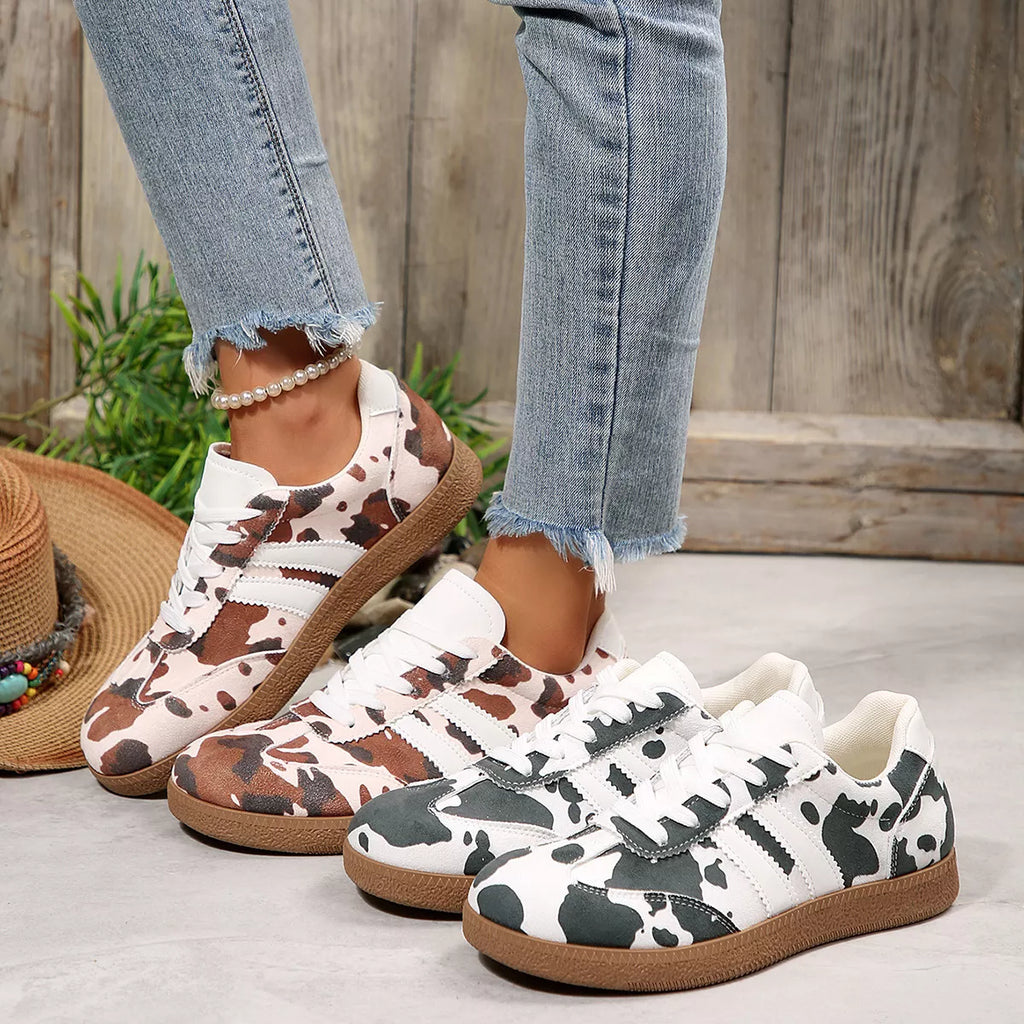Women's black cow print lace-up casual sneakers, side view