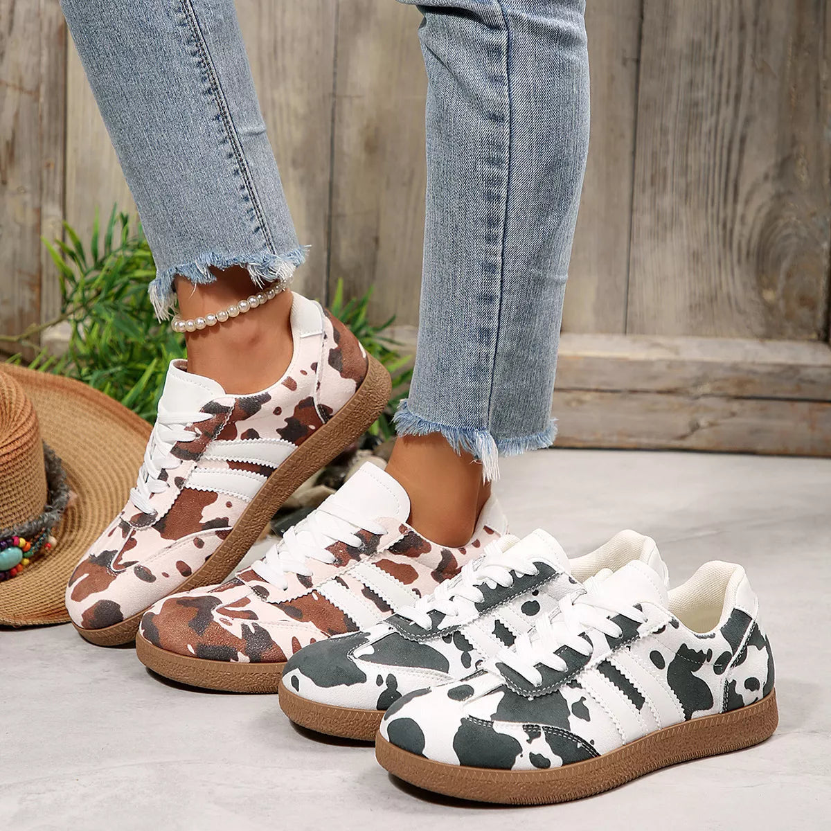 Women's black cow print lace-up casual sneakers, side view