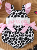 “Mama’s Girl cow print baby ruffle one‑piece in blush pink, front view
